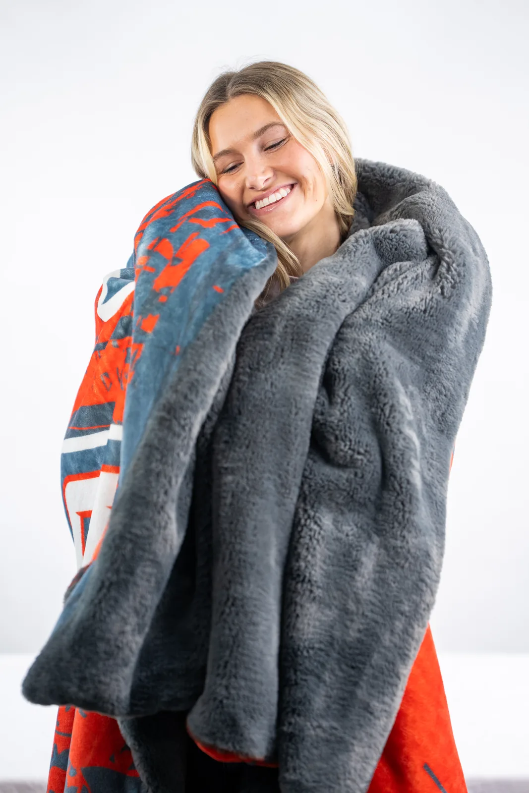 Someone wrapped in a plush Swanky blanket, the keepsake feel of a closing or milestone gift